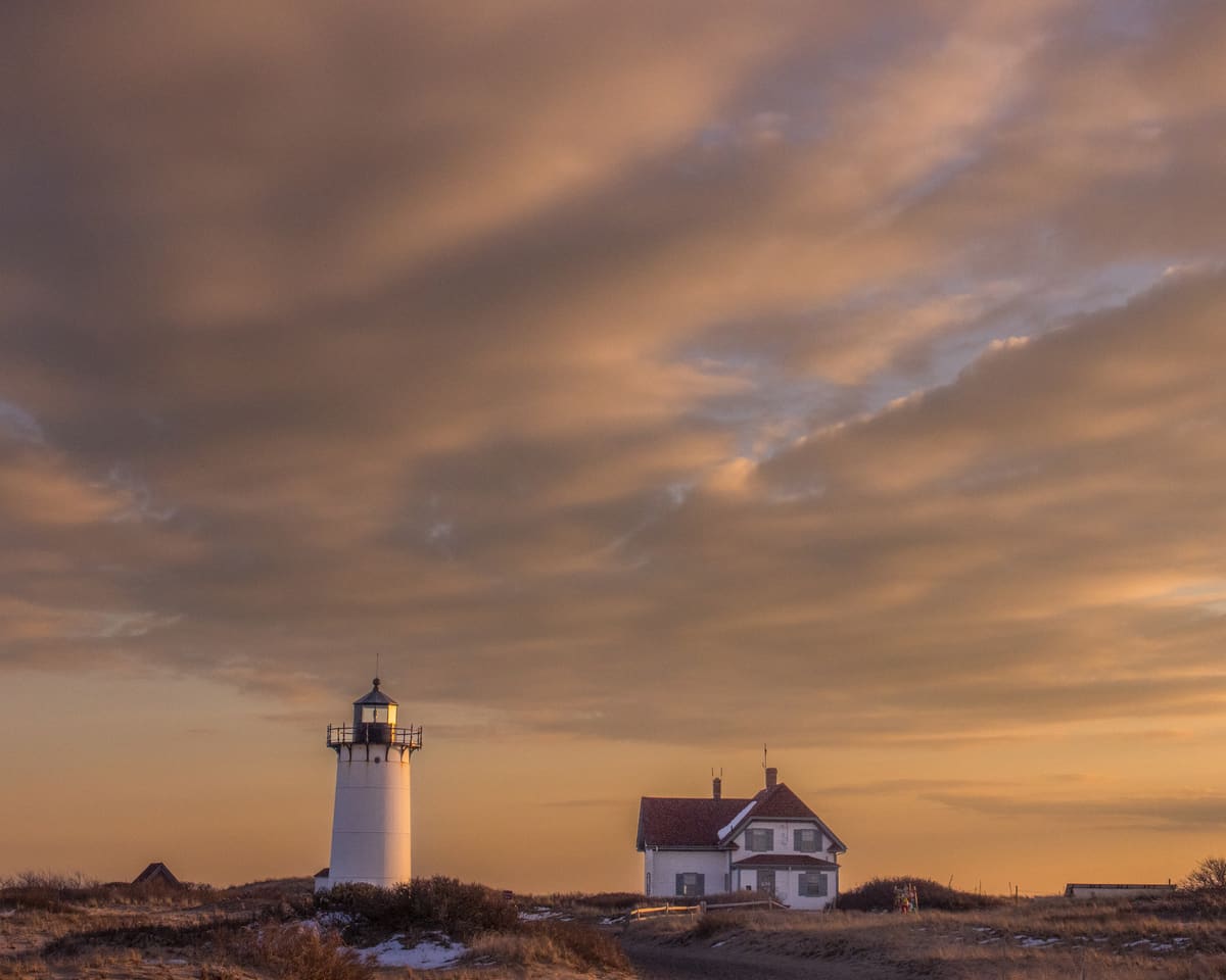 Race Point Light at sunset in Provincetown - a stunning stop on any Cape Cod lighthouse road trip
